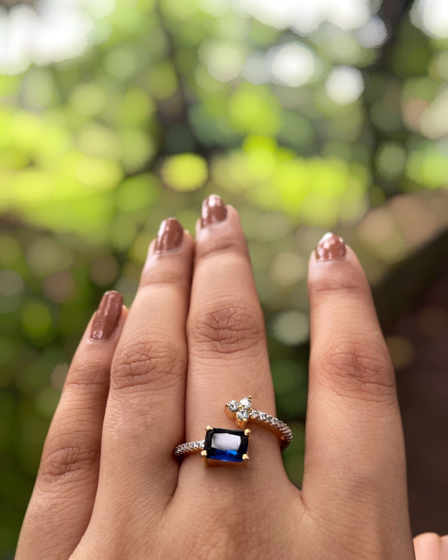 Ocean Vine | A Contemporary American Diamond ring with a striking blue stone, thin white-stone strand with delicate leaflets With 2 Tone Plating