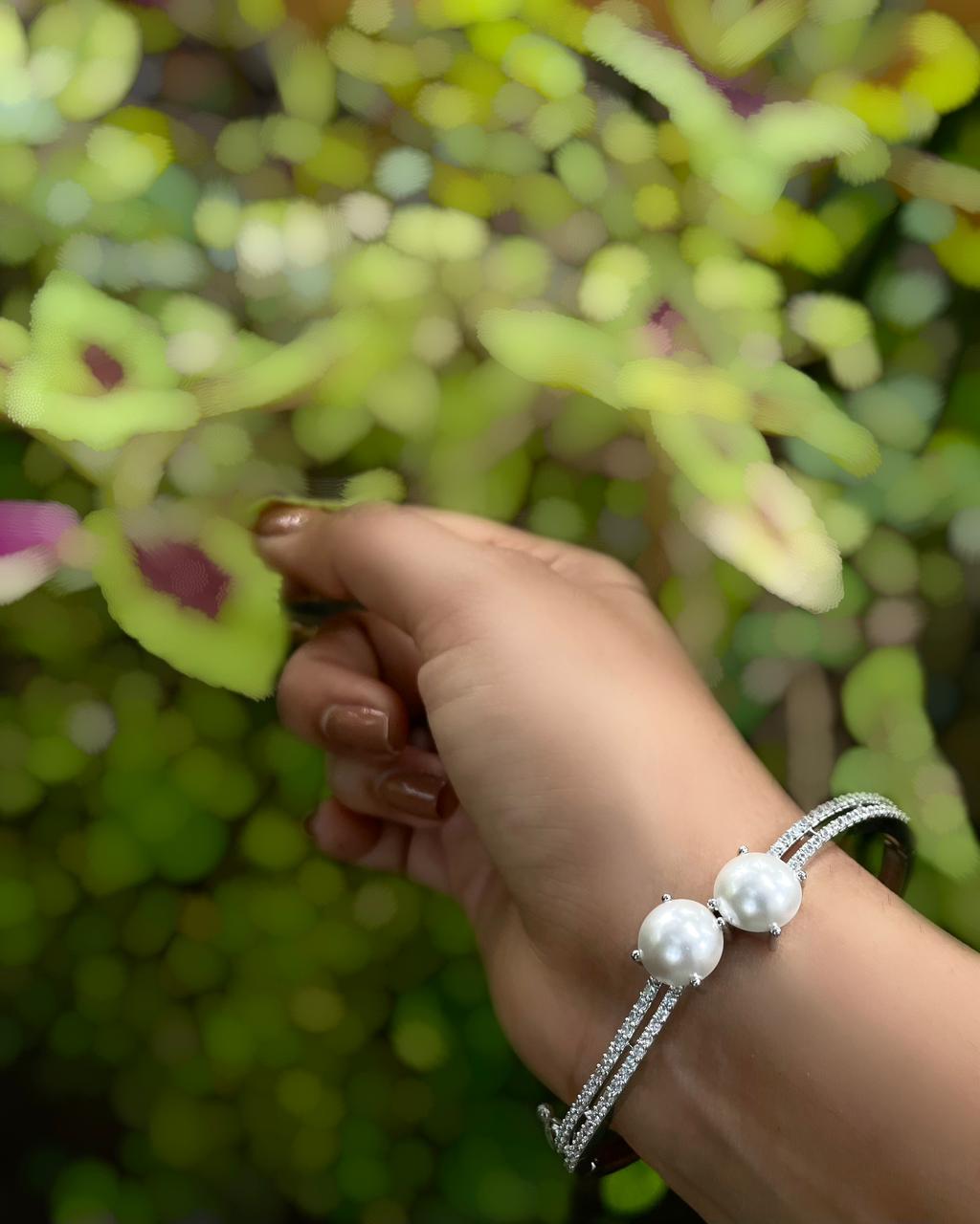 The White Muse | A rhodium-finished kada with twin pearls and fine American Diamond stones.