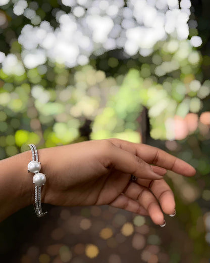 The White Muse | A rhodium-finished kada with twin pearls and fine American Diamond stones.