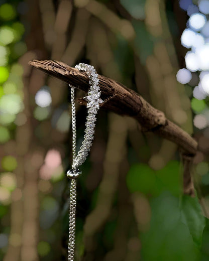 Daisy Thread | A rhodium-finished tennis-style bracelet featuring delicate American Diamond stones & a central bloom.
